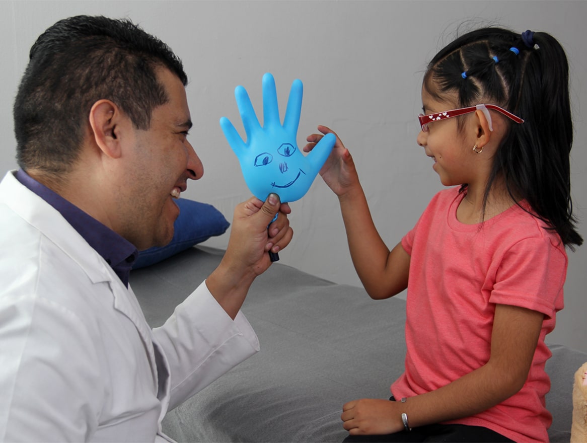 Doctor Handing Balloon to Child Patient